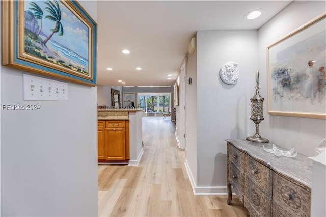 hallway with light hardwood / wood-style floors