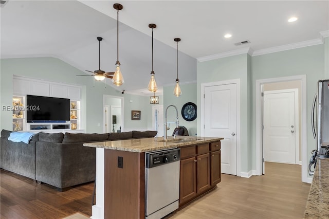 kitchen with a kitchen island with sink, dishwasher, sink, and light stone countertops