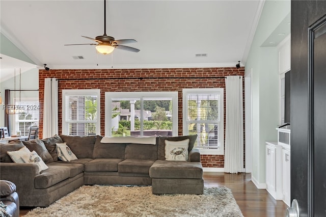 living room with crown molding, ceiling fan, brick wall, and dark hardwood / wood-style flooring