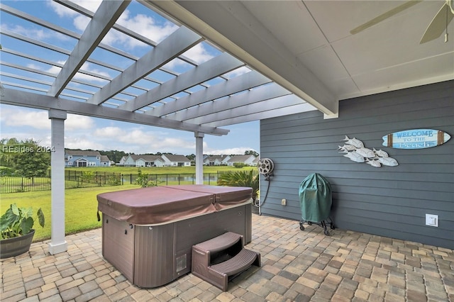 view of patio with a hot tub and a pergola