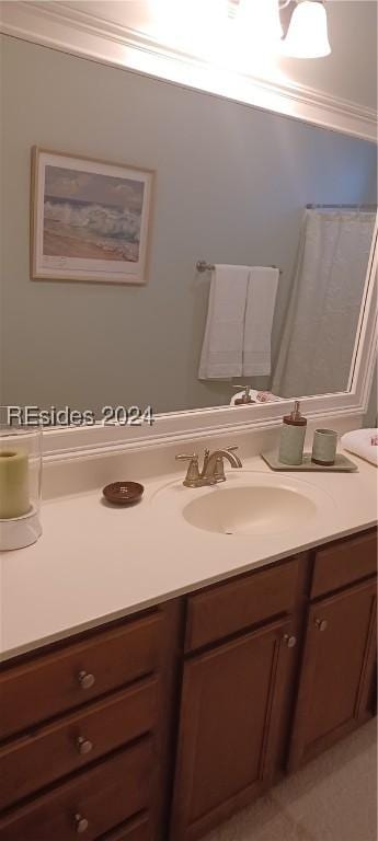 bathroom with crown molding and vanity