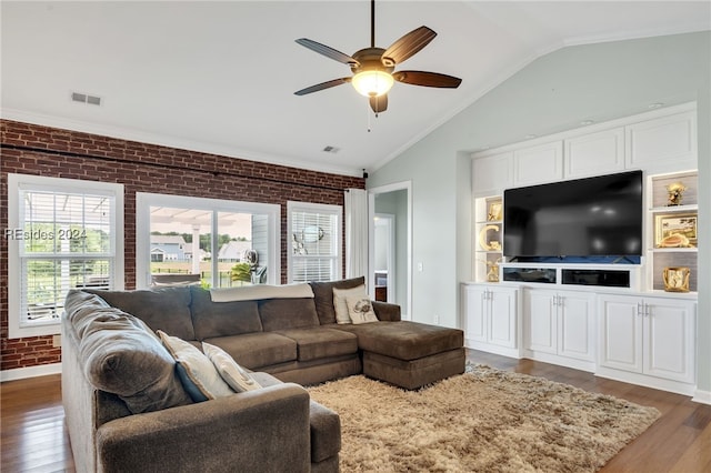 living room with dark hardwood / wood-style flooring, vaulted ceiling, ceiling fan, and brick wall