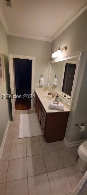 bathroom with tile patterned flooring, vanity, crown molding, and toilet