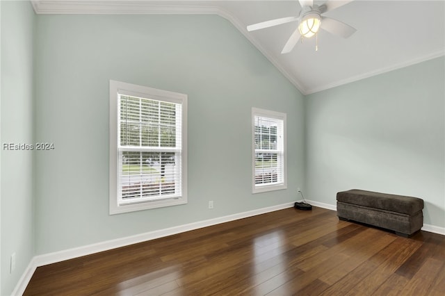 spare room featuring crown molding, dark wood-type flooring, high vaulted ceiling, and ceiling fan