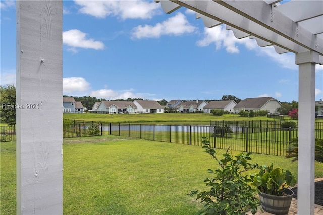 view of yard featuring a water view and a pergola