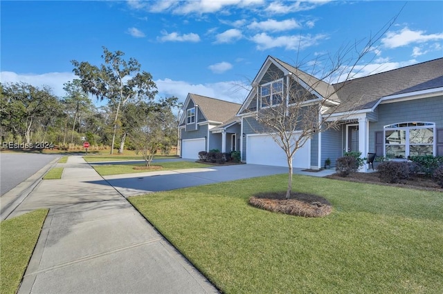 view of front of house featuring a garage and a front lawn