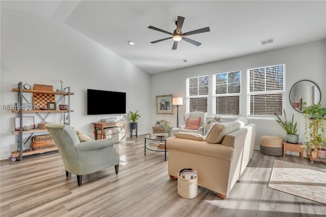 living room featuring light hardwood / wood-style flooring and ceiling fan