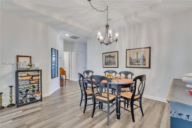 dining space featuring a chandelier and light hardwood / wood-style floors