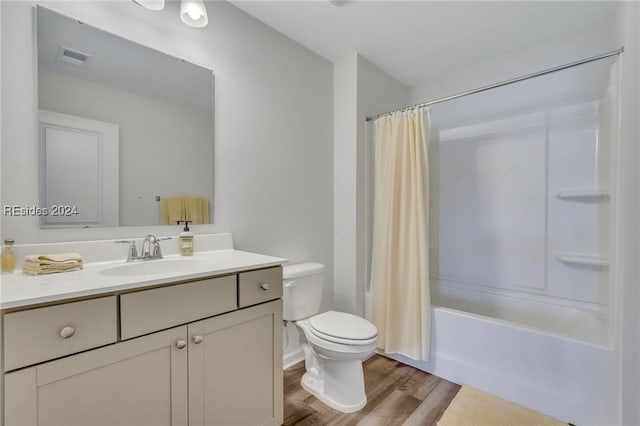 full bathroom featuring hardwood / wood-style flooring, shower / bath combo, vanity, and toilet