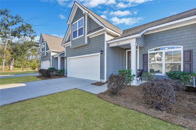 view of front facade with a garage and a front lawn