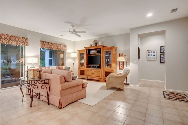 tiled living room featuring ceiling fan