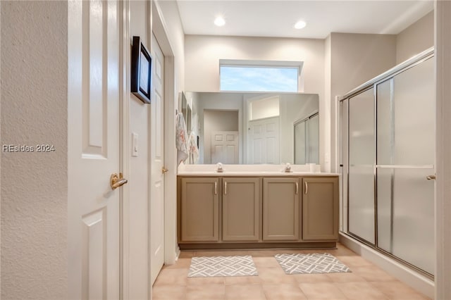 bathroom featuring vanity, tile patterned floors, and a shower with shower door