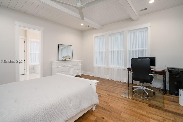 bedroom with beam ceiling, connected bathroom, ceiling fan, and light hardwood / wood-style flooring