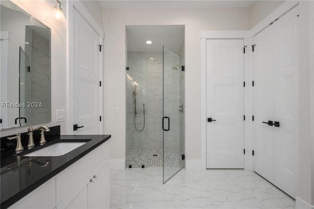 bathroom featuring vanity and a shower with shower door