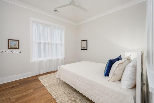 bedroom featuring wood-type flooring, crown molding, and ceiling fan