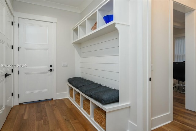 mudroom with ornamental molding and dark hardwood / wood-style floors