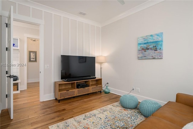 living room featuring ornamental molding and wood-type flooring