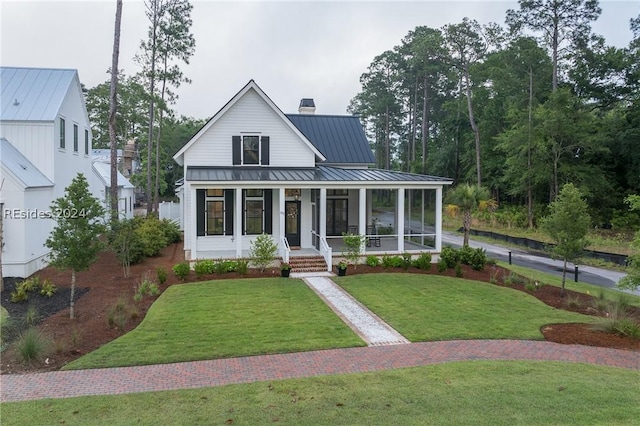 view of front of house with covered porch and a front yard