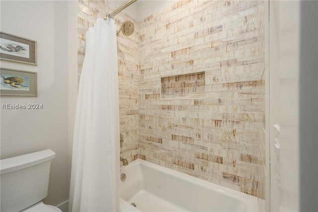 bathroom with shower / bath combination with curtain and toilet