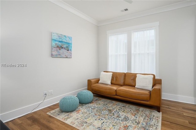 living room with ornamental molding and hardwood / wood-style floors