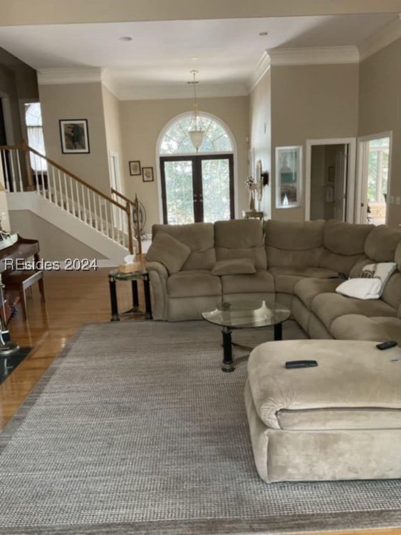 living room featuring hardwood / wood-style flooring and ornamental molding