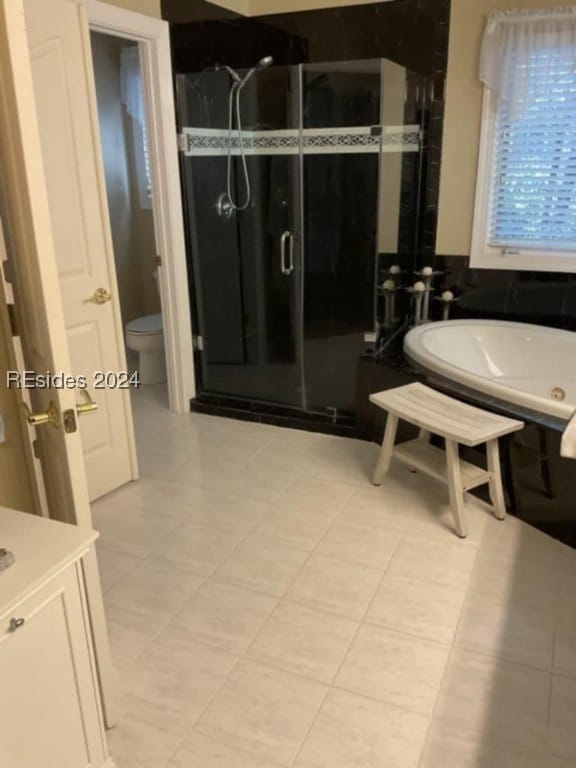 bathroom with tile patterned floors, plus walk in shower, and toilet