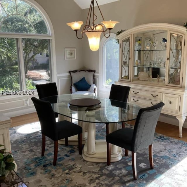 dining room with lofted ceiling and hardwood / wood-style floors