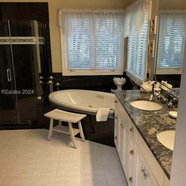 bathroom with independent shower and bath, vanity, a healthy amount of sunlight, and tile patterned flooring