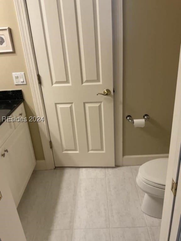 bathroom featuring tile patterned flooring, vanity, and toilet