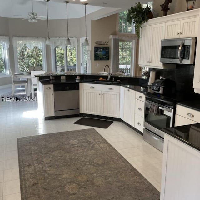 kitchen featuring white cabinetry, light tile patterned floors, and appliances with stainless steel finishes