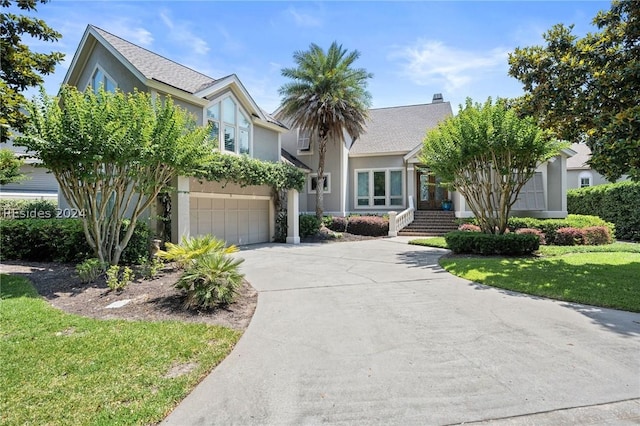 view of front of property with a garage and a front yard