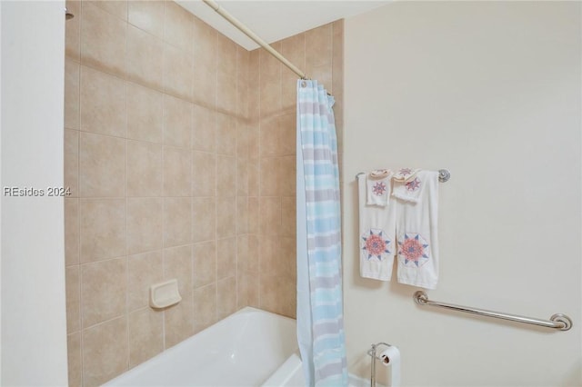 bathroom with shower / bathtub combination with curtain