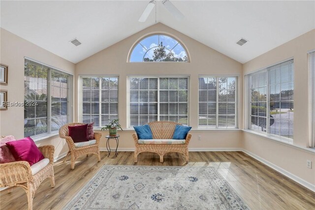 sunroom / solarium with lofted ceiling and ceiling fan