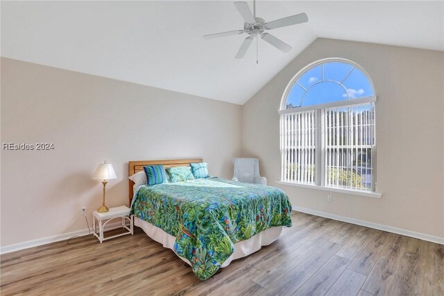 bedroom featuring ceiling fan, lofted ceiling, and wood-type flooring