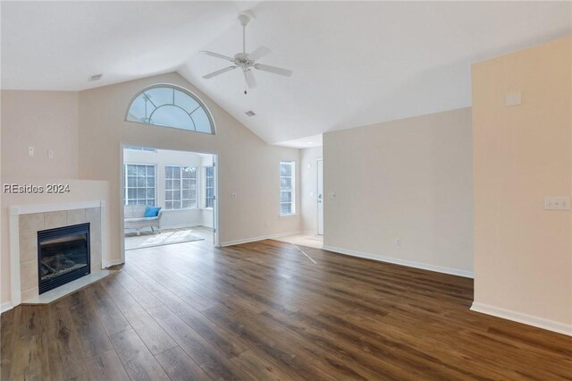 unfurnished living room featuring dark hardwood / wood-style flooring, a fireplace, lofted ceiling, and ceiling fan