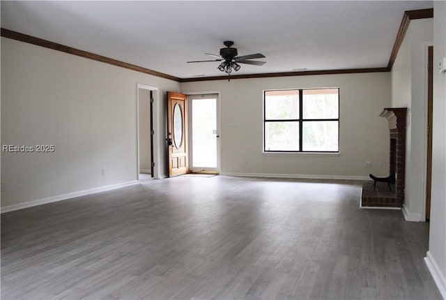 unfurnished living room featuring ornamental molding, a brick fireplace, dark hardwood / wood-style floors, and ceiling fan