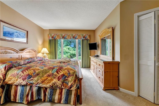 carpeted bedroom featuring a textured ceiling