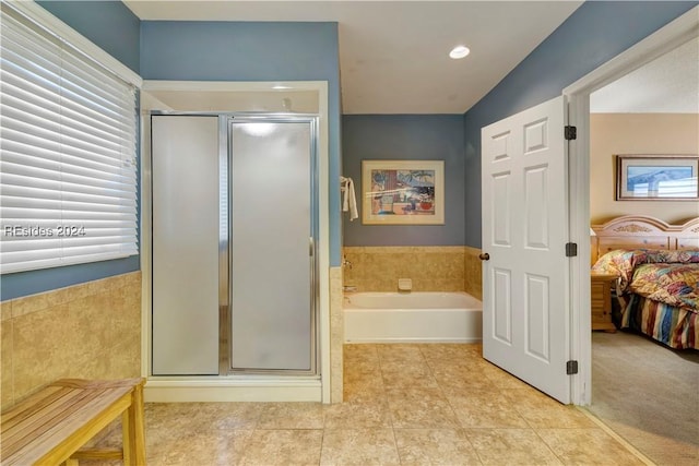 bathroom featuring plus walk in shower and tile patterned floors