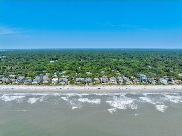 drone / aerial view featuring a water view and a view of the beach