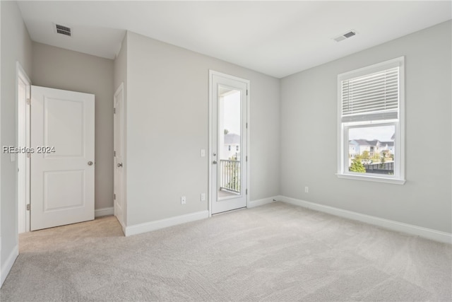 carpeted empty room featuring a healthy amount of sunlight