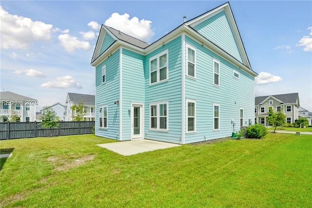 rear view of property with a patio and a yard