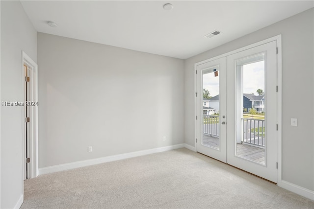 empty room with light colored carpet and french doors