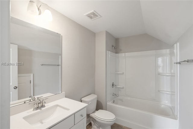 full bathroom featuring shower / washtub combination, toilet, vaulted ceiling, and vanity