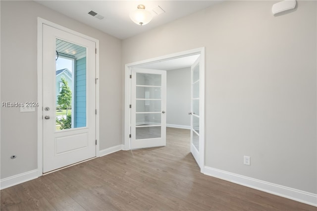 entryway featuring wood-type flooring and french doors