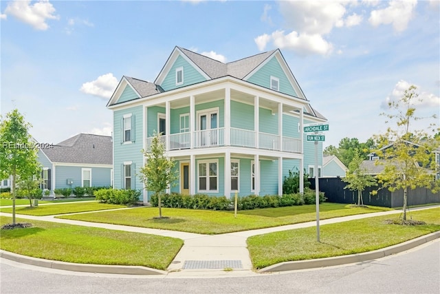 view of front of home featuring a front lawn and a balcony