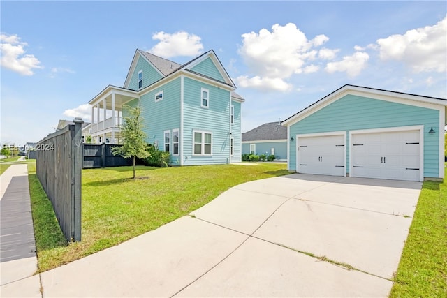 exterior space featuring a garage, a balcony, and a front lawn