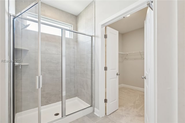 bathroom featuring a shower with door