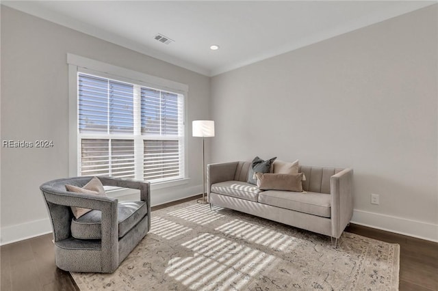 living room with hardwood / wood-style flooring and ornamental molding