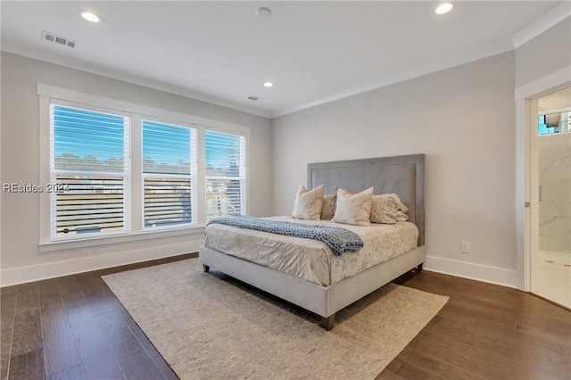 bedroom featuring crown molding and dark hardwood / wood-style flooring