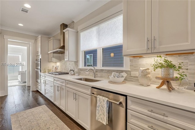 kitchen with sink, stainless steel appliances, white cabinets, and wall chimney exhaust hood